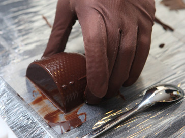 Confectioner prepares chocolate dessert