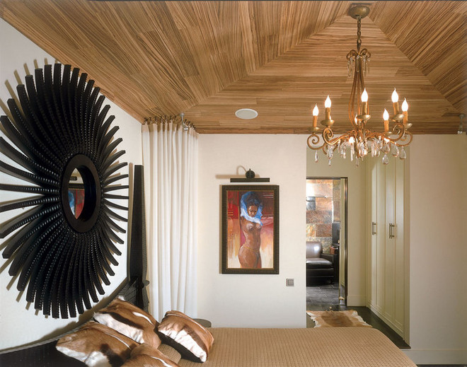African spirit bedroom gave hipped roof of zebrano and paintings by Mark Buku